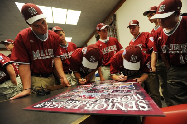 Members of the Maine District 3 baseball team gather around a poster to autograph it at Bangor City Hall on Thursday, Aug. 26, 2010 after they were honored for their second place showing in the Senior League World Series held in Bangor last week. (Bangor Daily News/Kevin Bennett) Members of the Maine District 3 baseball team gather around a poster to autograph it at Bangor City Hall on Thursday, Aug. 26, 2010 after they were honored for their second place showing in the Senior League World Series held in Bangor last week. (Bangor Daily News/Kevin Bennett)