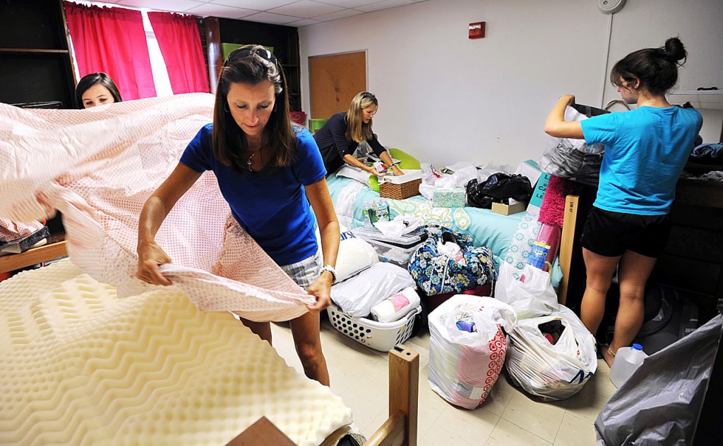 First-years students Whitney Callahan, right, of Rockport Mass. and her roommate Kelly Graham, left, of Merrimac N.H. get assistance from their mothers, Lisa Graham, second from left and Alison(cq) Callahan as the pair set up their dorm room at Oxford Hall on the University of Maine campus on Friday, August 28, 2010. (Bangor Daily News/Kevin Bennett) First-years students Whitney Callahan, right, of Rockport Mass. and her roommate Kelly Graham, left, of Merrimac N.H. get assistance from their mothers, Lisa Graham, second from left and Alison(cq) Callahan as the pair set up their dorm room at Oxford Hall on the University of Maine campus on Friday, August 28, 2010. (Bangor Daily News/Kevin Bennett)