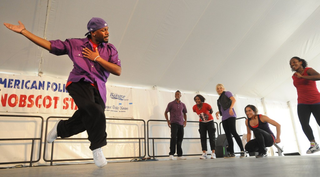 Junious Brickhouse (left) dances his solo during the Dance House portion of the Urban Artistry group during the American Folk Festival at the Penobscot Stage Stage Saturday. (Bangor Daily News/Gabor Degre) Junious Brickhouse (left) dances his solo during the Dance House portion of the Urban Artistry group during the American Folk Festival at the Penobscot Stage Stage Saturday. (Bangor Daily News/Gabor Degre)