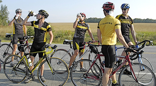 Riders with Spokes for Hope take a much welcomed hydration drink during day one of their four-day ride south from Fort Kent to Kittery in support of cancer awareness. On Friday they group rode 107-miles to Houlton in 90-degree heat. (Photo by Julia Bayly) Riders with Spokes for Hope take a much welcomed hydration drink during day one of their four-day ride south from Fort Kent to Kittery in support of cancer awareness. On Friday they group rode 107-miles to Houlton in 90-degree heat. (Photo by Julia Bayly)
