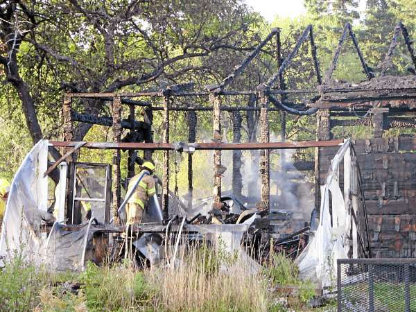 A firefighter hoses down burning embers in a gutted garage Sunday evening next to Route 1 in Sullivan. Local fire Chief Mike Hiser said the homeowner, who had been welding in the garage when the fire started shortly before 5 p.m., was taken to Maine Coast Memorial Hospital in Ellsworth to be treated for smoke inhalation. (Bangor Daily News/Bill Trotter) A firefighter hoses down burning embers in a gutted garage Sunday evening next to Route 1 in Sullivan. Local fire Chief Mike Hiser said the homeowner, who had been welding in the garage when the fire started shortly before 5 p.m., was taken to Maine Coast Memorial Hospital in Ellsworth to be treated for smoke inhalation. (Bangor Daily News/Bill Trotter)