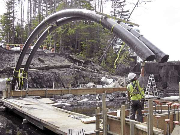 Abby Workers from Stetson & Watson contractors maneuver a carbon fiber tube over the Little River in Belfast on Wednesday, Sept. 22. The Herrick Road bridge, when completed, will be the largest so-called "bridge in a backpack" built in Maine. (Abigail Curtis/BDN) Abby Workers from Stetson & Watson contractors maneuver a carbon fiber tube over the Little River in Belfast on Wednesday, Sept. 22. The Herrick Road bridge, when completed, will be the largest so-called "bridge in a backpack" built in Maine. (Abigail Curtis/BDN)