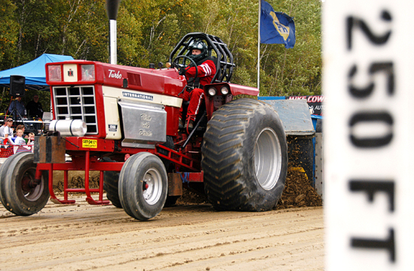 Peter Hurd of Morrill, Maine drivers his tractor, "Flirtin' With Disaster," hard during the Northern Timber Cruisers Truck Pull at Millinocket Regional Airport on Saturday. The tractor was digging in to the track so deeply that it could barely keep its front wheels grounded during its run down the track. BANGOR DAILY NEWS PHOTO BY NICK SAMBIDES JR. Peter Hurd of Morrill, Maine drivers his tractor, "Flirtin' With Disaster," hard during the Northern Timber Cruisers Truck Pull at Millinocket Regional Airport on Saturday. The tractor was digging in to the track so deeply that it could barely keep its front wheels grounded during its run down the track. BANGOR DAILY NEWS PHOTO BY NICK SAMBIDES JR.