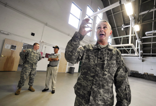 Staff Sgt. Dave Simmons (cq), rear detachment commander for the 172nd Infantry (Mountain) Regiment,Bravo Company, describes the ongoing renovations to the Maine Army National Guard's Brewer Armory, the company's home base Brewer, Maine. Behind him are Second Lt. William Skull, left, and Army veteran and former state legislator Charles " Dusty" Fisher. Photographed Sept. 28, 2010. (Bangor Daily News/John Clarke Russ) Staff Sgt. Dave Simmons (cq), rear detachment commander for the 172nd Infantry (Mountain) Regiment,Bravo Company, describes the ongoing renovations to the Maine Army National Guard's Brewer Armory, the company's home base Brewer, Maine. Behind him are Second Lt. William Skull, left, and Army veteran and former state legislator Charles " Dusty" Fisher. Photographed Sept. 28, 2010. (Bangor Daily News/John Clarke Russ)