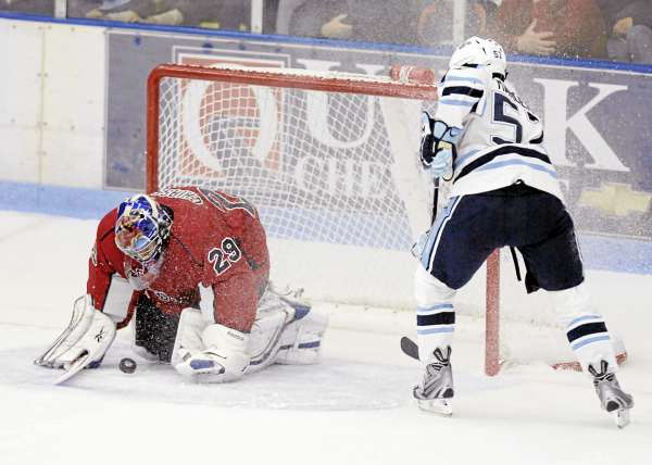Maine's Matt Mangene (57) looks to capitalize on a rebounding puck blocked by Acadia goalie Michael Chiasson (29) in the third period of their exhibition game in Orono, Maine, Saturday, Oct. 3, 2010. Bangor Daily News/Michael C. York Maine's Matt Mangene (57) looks to capitalize on a rebounding puck blocked by Acadia goalie Michael Chiasson (29) in the third period of their exhibition game in Orono, Maine, Saturday, Oct. 3, 2010. Bangor Daily News/Michael C. York