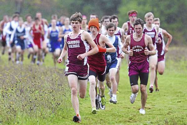 Caribou's Christian Sleeper leads the way early in the Penobscot Valley Conference cross country championship meet in Bangor Saturday. Ellsworth's Dan Curts (in hat) went on to win the race but Sleeper's Vikings won the team title. (BDN Photo by Jason Smith) Caribou's Christian Sleeper leads the way early in the Penobscot Valley Conference cross country championship meet in Bangor Saturday. Ellsworth's Dan Curts (in hat) went on to win the race but Sleeper's Vikings won the team title. (BDN Photo by Jason Smith)