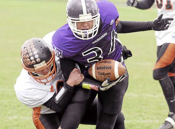 John Bapst High School's Mark Dieuveuil (right) is tackled by Rockland High School's Dan Stone during the first quarter of their Eastern Maine Class C quarterfinal game in Bangor Saturday. John Bapst won 31-0. (Bangor Daily News/Gabor Degre) John Bapst High School's Mark Dieuveuil (right) is tackled by Rockland High School's Dan Stone during the first quarter of their Eastern Maine Class C quarterfinal game in Bangor Saturday. John Bapst won 31-0. (Bangor Daily News/Gabor Degre)