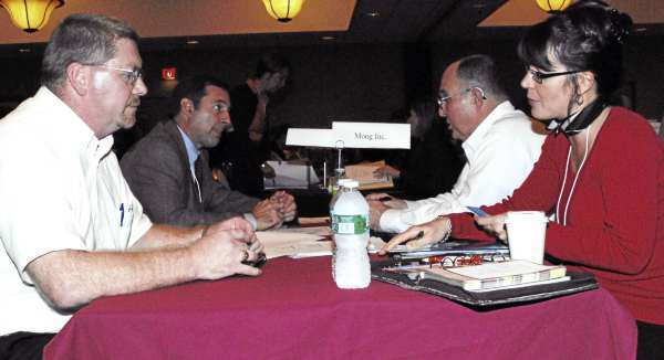 Will Rood, Left, president and CEO of B&B Precise Products Inc. of Benton, talks with Laura Gloss, subcontract manager with Buffalo, N.Y.-based MOOG Inc., during a match-making session held in South Portland. Rood would like his precision machine shop to do business with more prime contractors like MOOG. (Bangor Daily News/Matt Wickenheiser) Will Rood, Left, president and CEO of B&B Precise Products Inc. of Benton, talks with Laura Gloss, subcontract manager with Buffalo, N.Y.-based MOOG Inc., during a match-making session held in South Portland. Rood would like his precision machine shop to do business with more prime contractors like MOOG. (Bangor Daily News/Matt Wickenheiser)