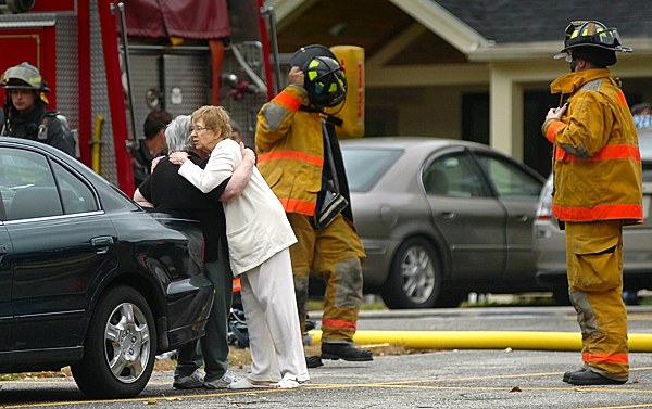 After they and others evacuated their apartments due to a fire in one of the units, Janet Henry, right, hugged fellow Holden Square resident Beverly Newenham at Holden Square off Upper Dedham Road in Holden Thursday afternoon, Oct. 7, 2010. Janet Henry said she was the first to spot smoke coming from the window of an elderly woman who was injured in the fire. Residents were quickly evacuated and Holden, Eddington, Orrington and Brewer Fire departments responded, with the first fire engine reaching the scene within four minutes, according to Holden/ Eddington Fire Chief Jim Ellis. (Bangor Daily News/John Clarke Russ) After they and others evacuated their apartments due to a fire in one of the units, Janet Henry, right, hugged fellow Holden Square resident Beverly Newenham at Holden Square off Upper Dedham Road in Holden Thursday afternoon, Oct. 7, 2010. Janet Henry said she was the first to spot smoke coming from the window of an elderly woman who was injured in the fire. Residents were quickly evacuated and Holden, Eddington, Orrington and Brewer Fire departments responded, with the first fire engine reaching the scene within four minutes, according to Holden/ Eddington Fire Chief Jim Ellis. (Bangor Daily News/John Clarke Russ)