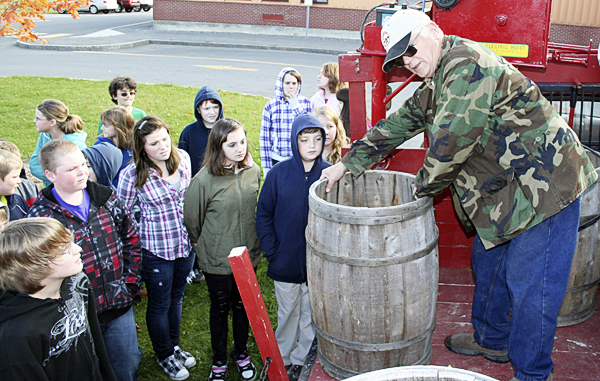 Richard Rand (right) of Presque Isle, brought his 1946 Chevrolet farm truck to the Presque Isle Middle School last week to talk to sixth-graders about how potato farming used to be done. Rand placed potatoes on a section of lawn at the school and had students pick the potatoes, place them in a basket and dump the potatoes into a barrel. PRESQUE ISLE STAR-HERALD PHOTO BY SCOTT MITCHELL JOHNSON Richard Rand (right) of Presque Isle, brought his 1946 Chevrolet farm truck to the Presque Isle Middle School last week to talk to sixth-graders about how potato farming used to be done. Rand placed potatoes on a section of lawn at the school and had students pick the potatoes, place them in a basket and dump the potatoes into a barrel. PRESQUE ISLE STAR-HERALD PHOTO BY SCOTT MITCHELL JOHNSON
