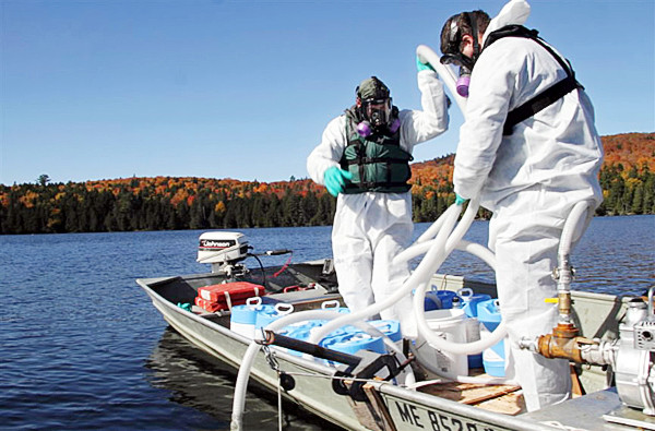 PHOTO CREDIT: MDIF&W Public Relations Rep Travis Barrett; BRP 7: Maine Department of Inland Fisheries and Wildlife biologists, who became licensed pesticide applicators, prepare pumps and hoses for infusion of liquid rotenone into the deep water pond. PHOTO CREDIT: MDIF&W Public Relations Rep Travis Barrett; BRP 7: Maine Department of Inland Fisheries and Wildlife biologists, who became licensed pesticide applicators, prepare pumps and hoses for infusion of liquid rotenone into the deep water pond.