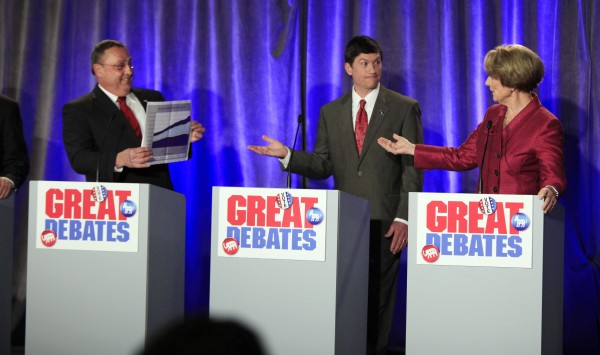 Republican gubernatorial candidate Paul LePage, left, holds up a chart while debating the state budget with Democratic candidate Elizabeth Mitchell, right, while independent candidate Kevin Scott, center, gets caught in the middle on Saturday during a debate in Portland. Republican gubernatorial candidate Paul LePage, left, holds up a chart while debating the state budget with Democratic candidate Elizabeth Mitchell, right, while independent candidate Kevin Scott, center, gets caught in the middle on Saturday during a debate in Portland.