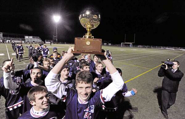 Bradley Wilcox (left) and Ben Groski (holding the trophy) lead the Bangor Christian team's victory parade past the stands after defeating Richmond High School 5-2 in the Class D boys state soccer championship in Hampden Saturday night. (Bangor Daily News/John Clarke Russ) Bradley Wilcox (left) and Ben Groski (holding the trophy) lead the Bangor Christian team's victory parade past the stands after defeating Richmond High School 5-2 in the Class D boys state soccer championship in Hampden Saturday night. (Bangor Daily News/John Clarke Russ)