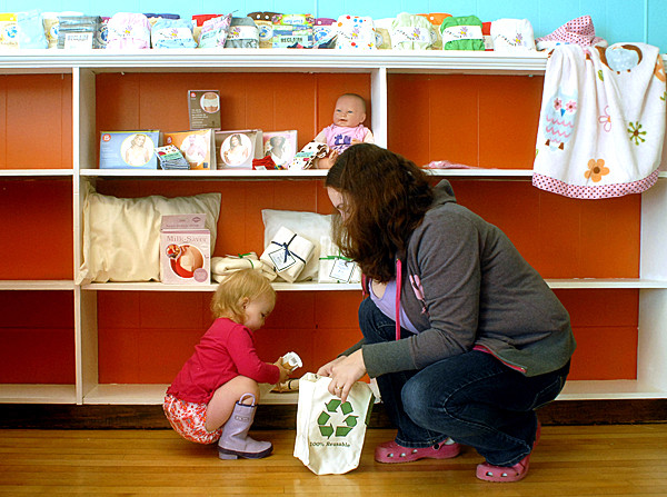 BANGOR, ME -- OCTOBER 13, 2010 --Beth Lundy and her daughter Zoe, 18 months, put items on shelves at Central Street Farmhouse, a new business coming to downtown Bangor which will feature home brewing, cheese making and wine on the first floor and a baby boutique on the second floor focusing on cloth diapers, nursing and carriers. LINDA COAN O'KRESIK BANGOR, ME -- OCTOBER 13, 2010 --Beth Lundy and her daughter Zoe, 18 months, put items on shelves at Central Street Farmhouse, a new business coming to downtown Bangor which will feature home brewing, cheese making and wine on the first floor and a baby boutique on the second floor focusing on cloth diapers, nursing and carriers. LINDA COAN O'KRESIK