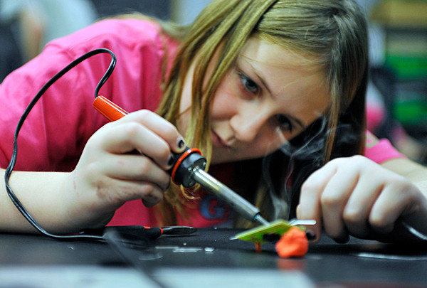 Rebecca Peterson, 11, of Girl Scout Troop 816 in Ellsworth solders the lead to a circuit board to power a light emitting diode while participating in Saturday's engineering education event at the University of Maine in Orono. A large group of Girl Scouts and their leaders from across the state came to U Maine to take part in Transforming Leadership: Engineering for their Future. (Bangor Daily News/John Clarke Russ) Rebecca Peterson, 11, of Girl Scout Troop 816 in Ellsworth solders the lead to a circuit board to power a light emitting diode while participating in Saturday's engineering education event at the University of Maine in Orono. A large group of Girl Scouts and their leaders from across the state came to U Maine to take part in Transforming Leadership: Engineering for their Future. (Bangor Daily News/John Clarke Russ)