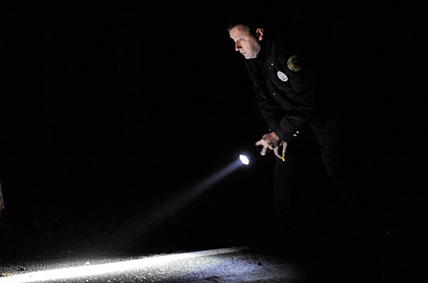 Bangor Police officer James Dearing uses his flashlight to scan the road surface for evidence after a compact car crashed on outer Essex Street in Bangor before 4 p.m. Tuesday, Nov. 16, 2010. One of the occupants died at the scene and the other occupant was transported to Eastern Maine Medical Center. (Bangor Daily News/John Clarke Russ) Bangor Police officer James Dearing uses his flashlight to scan the road surface for evidence after a compact car crashed on outer Essex Street in Bangor before 4 p.m. Tuesday, Nov. 16, 2010. One of the occupants died at the scene and the other occupant was transported to Eastern Maine Medical Center. (Bangor Daily News/John Clarke Russ)