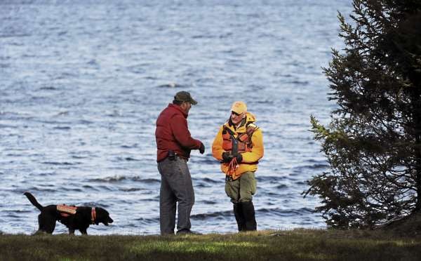 Jay Holweger, right, of Searsport talks with property owner Tom Pierce before working his dog Maddy along the shore line of Baker Brook Cove on Moosehead Lake in Tomhegan Township on Friday, November 19, 2010. Holweger is part of Maine Search and Rescue Dogs and his dog Maddy is certified in wilderness air scent tracking. The pair were searching for James Russell, who was last seen on Sunday. (Bangor Daily News/Kevin Bennett) Jay Holweger, right, of Searsport talks with property owner Tom Pierce before working his dog Maddy along the shore line of Baker Brook Cove on Moosehead Lake in Tomhegan Township on Friday, November 19, 2010. Holweger is part of Maine Search and Rescue Dogs and his dog Maddy is certified in wilderness air scent tracking. The pair were searching for James Russell, who was last seen on Sunday. (Bangor Daily News/Kevin Bennett)