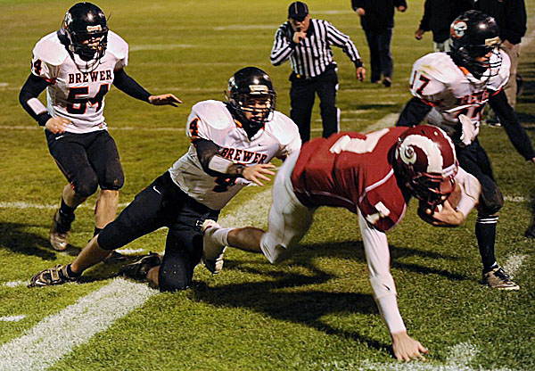 Bangor's Joe Seccareccia (right) is knocked out of bounds by Brewer's Brody Valley (4) and chased by Adam Lufkin (54) and Anthony Jackson (17) during their game in October at Cameron Stadium in Bangor. The Maine Principals' Association's football committee voted Thursday to stay with three classes in Maine high school football while Brewer will be moving back to Class B next season. (BDN File Photo) Bangor's Joe Seccareccia (right) is knocked out of bounds by Brewer's Brody Valley (4) and chased by Adam Lufkin (54) and Anthony Jackson (17) during their game in October at Cameron Stadium in Bangor. The Maine Principals' Association's football committee voted Thursday to stay with three classes in Maine high school football while Brewer will be moving back to Class B next season. (BDN File Photo)