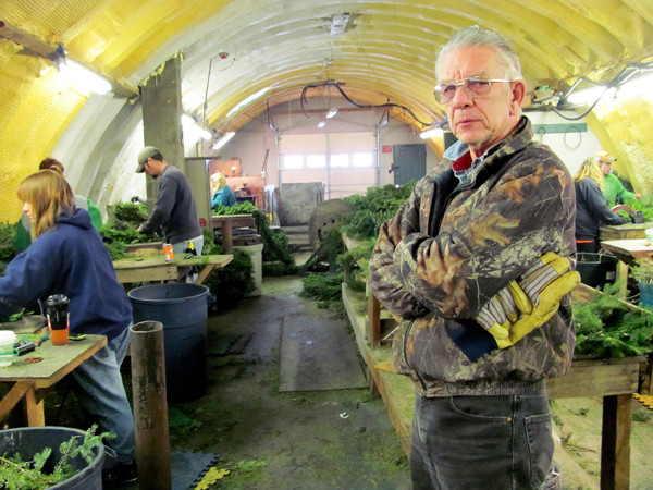 Ambrose "Tom" McCarthy Jr. of Skowhegan, owner of Central Maine Wreath, poses on December, 7, 2010, while about a dozen workers around him create wreaths, crosses, candy canes and kissing balls out of balsam fir. McCarthy, who has been in the wreath business for 31 years, estimates he's sold more than 25,000 wreaths this year. He called that a respectable tally, but it's a fraction of the company's peak production in the early 1990s. (Bangor Daily News/Christopher Cousins) Ambrose "Tom" McCarthy Jr. of Skowhegan, owner of Central Maine Wreath, poses on December, 7, 2010, while about a dozen workers around him create wreaths, crosses, candy canes and kissing balls out of balsam fir. McCarthy, who has been in the wreath business for 31 years, estimates he's sold more than 25,000 wreaths this year. He called that a respectable tally, but it's a fraction of the company's peak production in the early 1990s. (Bangor Daily News/Christopher Cousins)