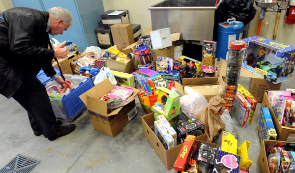 Bangor Police Detective Tim Reid looks through some of the stolen toys that were recovered from a Patten Street home Wedensday. The toys were alledgedly stolen from the Toys for Tots program by a person who volunteers there and who was selling them over the internet. The value of the toys will be be determined over the next day or two and early next week they will be returned to the Toys for Tots program. Police will try to find out if the theft happened over a several year period and it is expected that at least one person will be charged. (Bangor Daily News/Gabor Degre) Bangor Police Detective Tim Reid looks through some of the stolen toys that were recovered from a Patten Street home Wedensday. The toys were alledgedly stolen from the Toys for Tots program by a person who volunteers there and who was selling them over the internet. The value of the toys will be be determined over the next day or two and early next week they will be returned to the Toys for Tots program. Police will try to find out if the theft happened over a several year period and it is expected that at least one person will be charged. (Bangor Daily News/Gabor Degre)