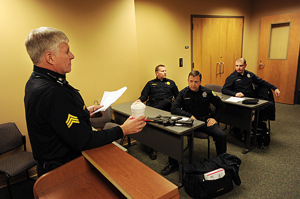 Sgt. Bob Bishop, left, leads a roll call for an evening shift of officers headed out on patrol at the Bangor Police Station on Wednesday, December 10, 2010. Within the next three years, almost one-third of the force (28 of 83 officers) will be eligible for retirement. Attending the roll call are officers Jeff Millard, second left, Jim Dearing and John Robinson, right. Bishop, a 26 -year veteran of the force, is already eligible for retirement and Millard, who started in 1986 is eligible in 2011. (Bangor Daily News/Kevin Bennett) Sgt. Bob Bishop, left, leads a roll call for an evening shift of officers headed out on patrol at the Bangor Police Station on Wednesday, December 10, 2010. Within the next three years, almost one-third of the force (28 of 83 officers) will be eligible for retirement. Attending the roll call are officers Jeff Millard, second left, Jim Dearing and John Robinson, right. Bishop, a 26 -year veteran of the force, is already eligible for retirement and Millard, who started in 1986 is eligible in 2011. (Bangor Daily News/Kevin Bennett)