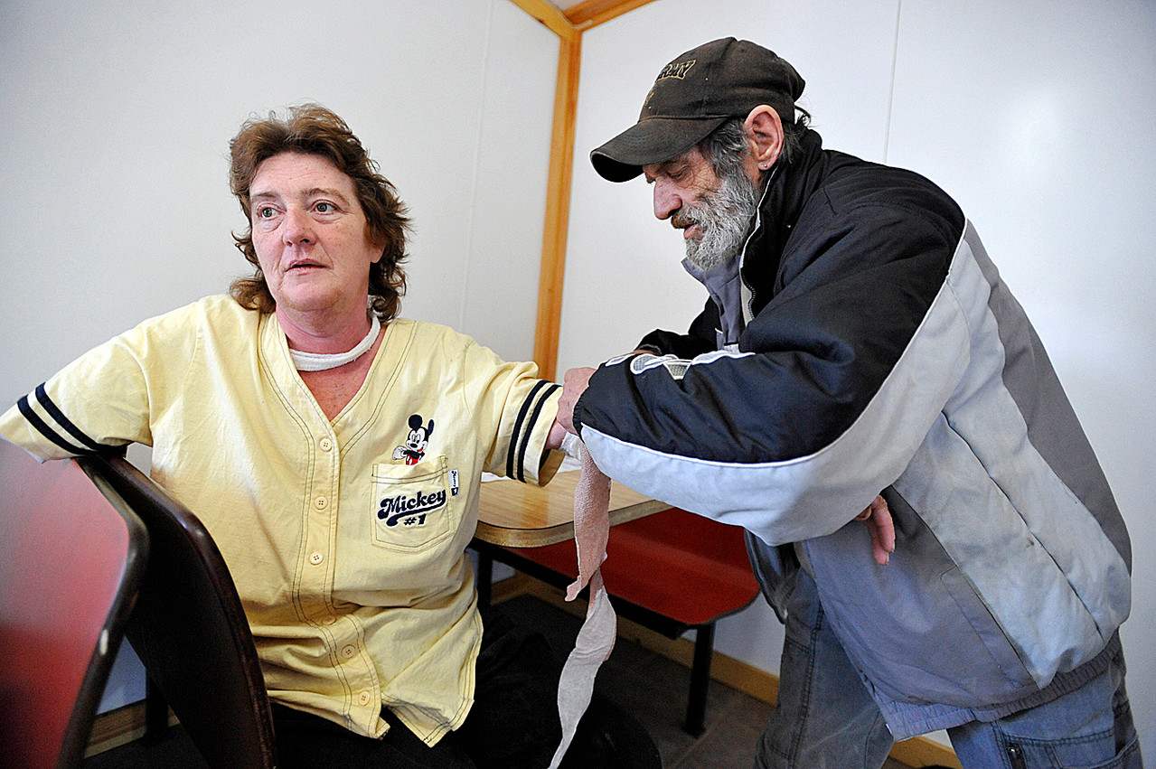 At Four Corners Variety in LaGrange Sunday, Dec. 19, 2010, Karen Stewart ,left, talked with the BDN about last month's dog attack in LaGrange. Checking her bandages was close friend Vaughn Adams who is helping her recuperate at his home in LaGrange for the next several months. Last month, doctors in Boston had to remove most of her right arm and they grafted skin from her thigh to repair the skin on her left arm that was torn and infected by the attack. (Bangor Daily News/John Clarke Russ) At Four Corners Variety in LaGrange Sunday, Dec. 19, 2010, Karen Stewart ,left, talked with the BDN about last month's dog attack in LaGrange. Checking her bandages was close friend Vaughn Adams who is helping her recuperate at his home in LaGrange for the next several months. Last month, doctors in Boston had to remove most of her right arm and they grafted skin from her thigh to repair the skin on her left arm that was torn and infected by the attack. (Bangor Daily News/John Clarke Russ)