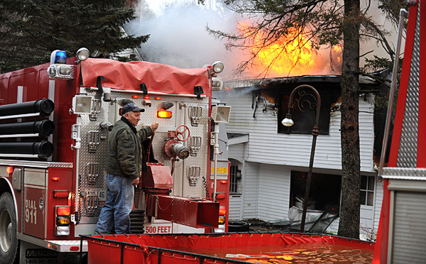 Tanker trucks formed a line to keep a portable tank filled with water at 14 Twining Road in Winterport on Tuesday, December 21, 2010. Kyle Stoops, property owner was playing with a new dog outside in a back yard when he noticed his house on fire. (Bangor Daily News/Kevin Bennett) Tanker trucks formed a line to keep a portable tank filled with water at 14 Twining Road in Winterport on Tuesday, December 21, 2010. Kyle Stoops, property owner was playing with a new dog outside in a back yard when he noticed his house on fire. (Bangor Daily News/Kevin Bennett)