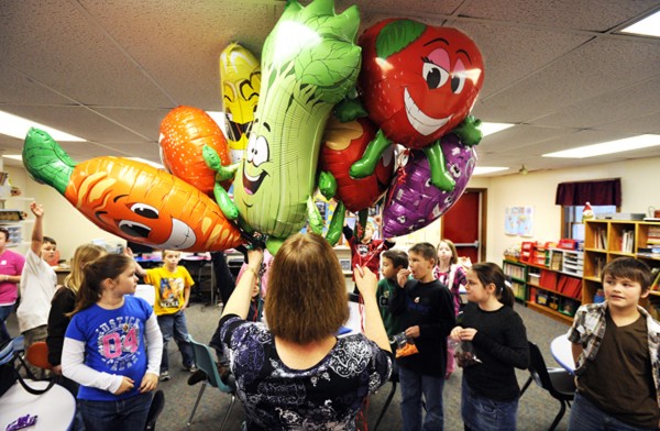 Morison Elementary School nurse Sue Parker (center) solicits votes on which helium-filled balloon character Deb Dearborn’s fourth-grade class wants for its class mascot earlier this month. The balloons serve as reminders of the school’s 5-2-1-0 Let’s Go! program, which is designed to promote healthy living. Parker was awarded a federal grant to purchase snowshoes to allow students the opportunity to explore the school’s walking trails once they are covered with snow. Morison Elementary School nurse Sue Parker (center) solicits votes on which helium-filled balloon character Deb Dearborn’s fourth-grade class wants for its class mascot earlier this month. The balloons serve as reminders of the school’s 5-2-1-0 Let’s Go! program, which is designed to promote healthy living. Parker was awarded a federal grant to purchase snowshoes to allow students the opportunity to explore the school’s walking trails once they are covered with snow.