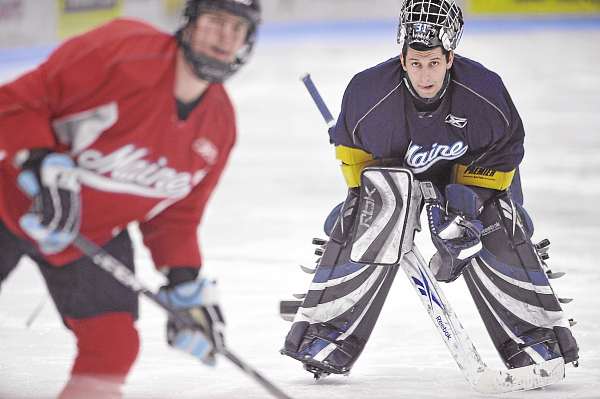 UMaine goalie Josh Seeley (right) catches his breath as he watches teammate Mark Antoine take shots during practice Wednesday morning at Alfond Arena in Orono. Seeley, a fourth-string goalie from Howland, has enjoyed his time with the Black Bear hockey team and hopes to coach after graduation. UMaine goalie Josh Seeley (right) catches his breath as he watches teammate Mark Antoine take shots during practice Wednesday morning at Alfond Arena in Orono. Seeley, a fourth-string goalie from Howland, has enjoyed his time with the Black Bear hockey team and hopes to coach after graduation.