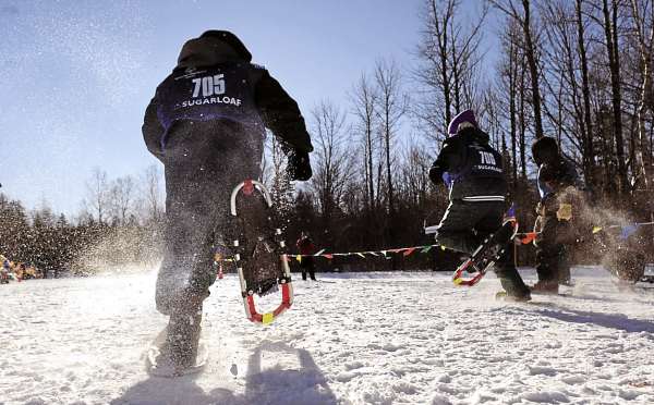 Daigen Pierpont, 11 (left) of the Thomaston Clippers, kicks up the snow as he and other competitors (ages 8-15) make their way down the course in the 100-meter snowshoe dash time trials during the 2011 Special Olympics Maine Winter Games at the Carrabasset Valley Academy Monday, Jan. 31, 2011. Daigen Pierpont, 11 (left) of the Thomaston Clippers, kicks up the snow as he and other competitors (ages 8-15) make their way down the course in the 100-meter snowshoe dash time trials during the 2011 Special Olympics Maine Winter Games at the Carrabasset Valley Academy Monday, Jan. 31, 2011.