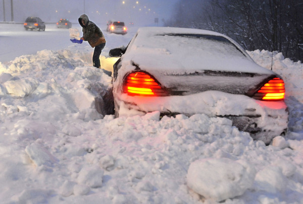 Roy Williams of Westfield, Mass., shovels snow in front of his vehicle on a merge ramp on Interstate 91 southbound during a winter storm in Windsor, Conn., Wednesday, Jan. 12, 2011. Williams said a plow clearing the highway passed by and blocked him in. (AP Photo/Jessica Hill) Roy Williams of Westfield, Mass., shovels snow in front of his vehicle on a merge ramp on Interstate 91 southbound during a winter storm in Windsor, Conn., Wednesday, Jan. 12, 2011. Williams said a plow clearing the highway passed by and blocked him in. (AP Photo/Jessica Hill)
