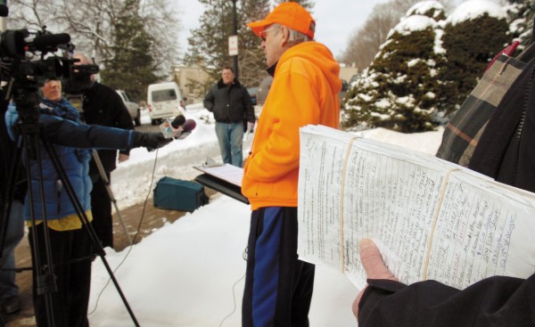 Bob Cimbollek, center, talks with reporters during a press conference at Bangor City Hall on Friday, January, 14, 2011 as Ken Wicks, right, holds a petition containing more than the 2, 236 signatures necessary to force a referendum on the propsed $65 million Bangor Arena project. The two filed the petition with the city clerk moments later. BDN Photo by Kevin Bennett Bob Cimbollek, center, talks with reporters during a press conference at Bangor City Hall on Friday, January, 14, 2011 as Ken Wicks, right, holds a petition containing more than the 2, 236 signatures necessary to force a referendum on the propsed $65 million Bangor Arena project. The two filed the petition with the city clerk moments later. BDN Photo by Kevin Bennett