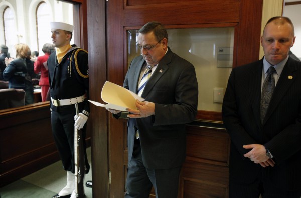 Gov. Paul LePage (center) reviews his notes while waiting to be introduced in the House chamber Thursday, Jan. 6, 2011, at the State House in Augusta, Maine. On his first day in office, LePage's activities included the swearing in of three new constitutional officers. Gov. Paul LePage (center) reviews his notes while waiting to be introduced in the House chamber Thursday, Jan. 6, 2011, at the State House in Augusta, Maine. On his first day in office, LePage's activities included the swearing in of three new constitutional officers.