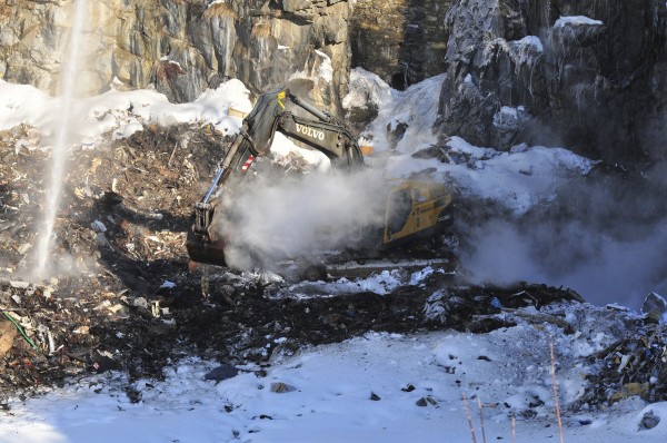 Rockland firefighters hose down smoldering debris while an excavator claws at the contents of the city landfill on Saturday.
Rockland firefighters hose down smoldering debris while an excavator claws at the contents of the city landfill on Saturday.