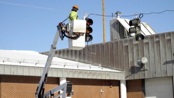 Workers with the Maine Department of Transportation were in Fort Kent this week installing 11 signal lights that will control the flow of heavy truck traffic over the international bridge connecting Fort Kent to Clair, New Brunswick, beginning Friday, Feb. 4. A computerized camera will trigger the system, allowing trucks onto the bridge in 10-minute intervals. Workers with the Maine Department of Transportation were in Fort Kent this week installing 11 signal lights that will control the flow of heavy truck traffic over the international bridge connecting Fort Kent to Clair, New Brunswick, beginning Friday, Feb. 4. A computerized camera will trigger the system, allowing trucks onto the bridge in 10-minute intervals.