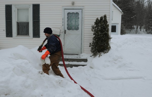 Curtis Emerson prepares to pump 40 gallons of oil into the house of a family on heat assistance on Oak Street in Ellsworth on Tuesday. Money provided by the state to assist low-income Mainers who need help heating their homes is critically low. Curtis Emerson prepares to pump 40 gallons of oil into the house of a family on heat assistance on Oak Street in Ellsworth on Tuesday. Money provided by the state to assist low-income Mainers who need help heating their homes is critically low.