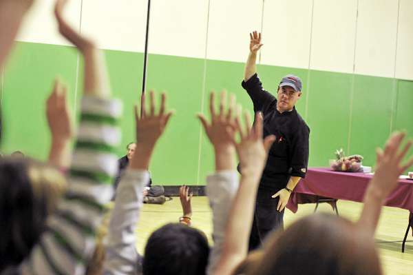 Many hands went up when Anthony Bussiere, a corporate executive chef with North Center Foods in Augusta, asked fifth and sixth graders whether a tomato is a fruit or a vegetable during his presentation at Warsaw Middle School in Pittsfield Thursday afternoon, March 10, 2011. Bussiere gave a one hour talk on fruits and vegetables and their dietary importance. Students were then treated to a sampling of common and exotic produce from Maine and afar. Many hands went up when Anthony Bussiere, a corporate executive chef with North Center Foods in Augusta, asked fifth and sixth graders whether a tomato is a fruit or a vegetable during his presentation at Warsaw Middle School in Pittsfield Thursday afternoon, March 10, 2011. Bussiere gave a one hour talk on fruits and vegetables and their dietary importance. Students were then treated to a sampling of common and exotic produce from Maine and afar.