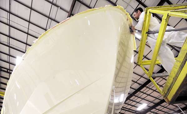 Zach Hamilton works on cutting the flange from the hull of a Sabre 46 after it was removed from the mold at Sabre Yachts' Rockland facility on Friday. The company produces high-end power and sail boats. Zach Hamilton works on cutting the flange from the hull of a Sabre 46 after it was removed from the mold at Sabre Yachts' Rockland facility on Friday. The company produces high-end power and sail boats.