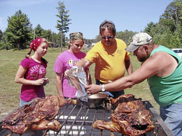 The Harmony community turned out in force in August for Caitlin McKenney of Harmony, who had a kidney removed because of a cancerous tumor. A pig roast and a free concert by Jillian Cardarelli and her band of Haverhill, Mass. were held as a fund-raising event. Helping to roast the pigs were (from left) Erica Lommel, Madison Chadbourne, Jeff Chadbourne and Darren Huff. The Harmony community turned out in force in August for Caitlin McKenney of Harmony, who had a kidney removed because of a cancerous tumor. A pig roast and a free concert by Jillian Cardarelli and her band of Haverhill, Mass. were held as a fund-raising event. Helping to roast the pigs were (from left) Erica Lommel, Madison Chadbourne, Jeff Chadbourne and Darren Huff.