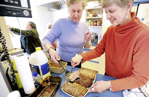 Leta Mathews (left) and Nancy Ives prepare meatloaf before the Downeast Table of Plenty free community supper at the Maine Seacoast Mission in Millbridge Sunday. They were among the members of the Cherryfield Congregational Church who provided the food for the supper. About eight groups cook the meals for the community meal that started four months ago. 50-80 people usually attend. Leta Mathews (left) and Nancy Ives prepare meatloaf before the Downeast Table of Plenty free community supper at the Maine Seacoast Mission in Millbridge Sunday. They were among the members of the Cherryfield Congregational Church who provided the food for the supper. About eight groups cook the meals for the community meal that started four months ago. 50-80 people usually attend.
