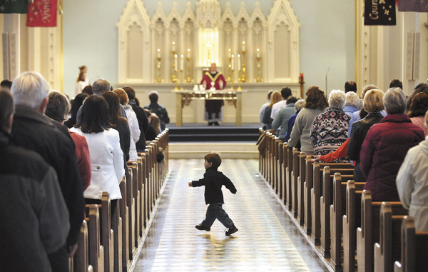 A boy walks in the center aisle of the St. John Catholic Church during Ash Wednesday service in Bangor Wednesday morning. A boy walks in the center aisle of the St. John Catholic Church during Ash Wednesday service in Bangor Wednesday morning.