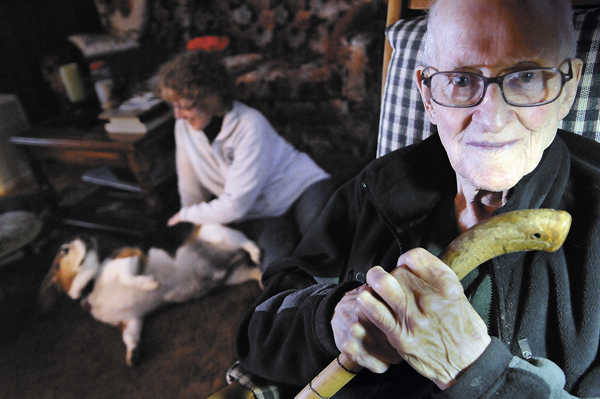 Pictured at his home in Milo with daughter Cecilia Harmon (in background) of Milo and his beagle "Tucker", Cecil Miller, 95, says he has many fond memories of working for various railroads that span New England and Canada. Retired for over 35 years, he said he spent much of his career as a train engineer. Pictured at his home in Milo with daughter Cecilia Harmon (in background) of Milo and his beagle "Tucker", Cecil Miller, 95, says he has many fond memories of working for various railroads that span New England and Canada. Retired for over 35 years, he said he spent much of his career as a train engineer.