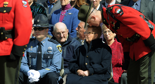 Deputy Chief Gregory Sanborn (right), leans in to talk to Rita Gordon, wife of deceased Warden pilot Daryl Gordon as Gordon's funeral procession rolls up to the Augusta Civic Center on Wednesday. Deputy Chief Gregory Sanborn (right), leans in to talk to Rita Gordon, wife of deceased Warden pilot Daryl Gordon as Gordon's funeral procession rolls up to the Augusta Civic Center on Wednesday.