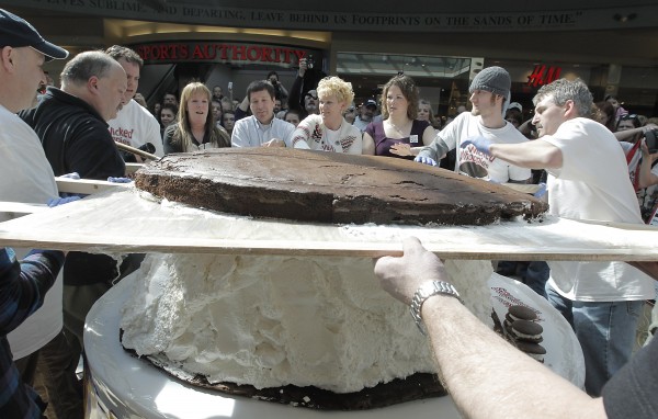 Amy Bouchard, owner of Wicked Whoopies (fourth from right), gets help putting the 180 pound devils food cake top on the 1000-plus pound whoopie pie at the Maine Mall in South Portland, Saturday. Competing with Pennsylvania to be the "Whoopie Pie State", Maine is looking to officially make the Whoopie Pie the State Treat. Amy Bouchard, owner of Wicked Whoopies (fourth from right), gets help putting the 180 pound devils food cake top on the 1000-plus pound whoopie pie at the Maine Mall in South Portland, Saturday. Competing with Pennsylvania to be the "Whoopie Pie State", Maine is looking to officially make the Whoopie Pie the State Treat.