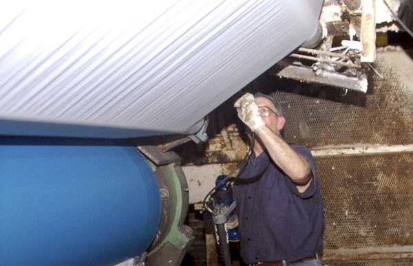 Philip Lindquist, 50, of Lincoln, examines paper as it rolls off one of two large papermaking machines at Lincoln Paper and Tissue LLC on Friday. Philip Lindquist, 50, of Lincoln, examines paper as it rolls off one of two large papermaking machines at Lincoln Paper and Tissue LLC on Friday.