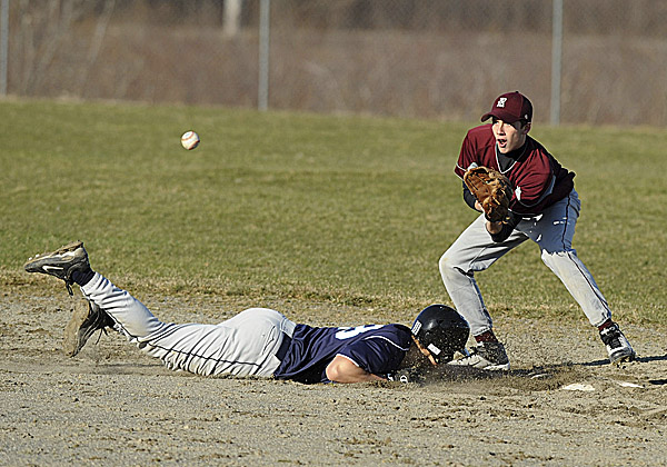 Lewis Francis of Calais High School dives back into second base during a pickoff attempt in the fourth inning of Friday's baseball season opener in East Machias against Washington Academy. WA's Alex Currier awaits the throw. Calais won 14-2. Lewis Francis of Calais High School dives back into second base during a pickoff attempt in the fourth inning of Friday's baseball season opener in East Machias against Washington Academy. WA's Alex Currier awaits the throw. Calais won 14-2.