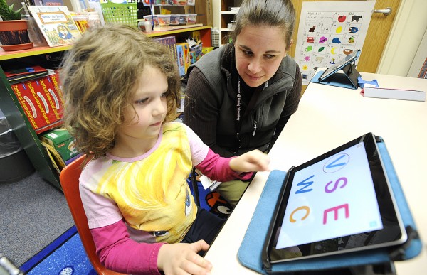 Rhianah Landry, 5, a kindergarten student at Washburn Elementary School in Auburn, works with literacy instructor Mauri Dufour on a borrowed Apple iPad 2 tablet computer Thursday. Educators were excited about a School Committee decision Wednesday to give all Auburn kindergarten students iPad 2 tablets in the fall. Rhianah used the notebook to hear a story and to learn her letters. Rhianah Landry, 5, a kindergarten student at Washburn Elementary School in Auburn, works with literacy instructor Mauri Dufour on a borrowed Apple iPad 2 tablet computer Thursday. Educators were excited about a School Committee decision Wednesday to give all Auburn kindergarten students iPad 2 tablets in the fall. Rhianah used the notebook to hear a story and to learn her letters.