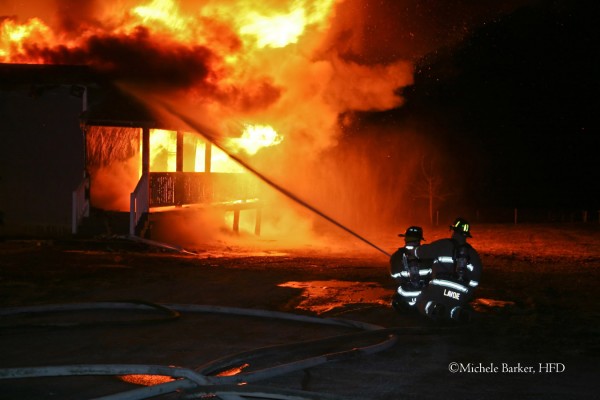 Firefighters from Glenburn Fire Department attack an early Wednesday morning fire in Charleston from the side of the home. The firefighter at right is Chris Lavoie from Glenburn Fire. Firefighters from Glenburn Fire Department attack an early Wednesday morning fire in Charleston from the side of the home. The firefighter at right is Chris Lavoie from Glenburn Fire.
