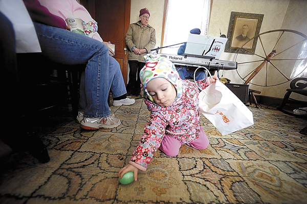 Breah Curtis of Newburgh retrieves an Easter egg that fell from her bag as she and her big sister Molly Curtis, 3 and her mom Amy Curtis (both not pictured) listened to Bangor musician and Curran Homestead board member Jerry Hughes (in background) play old time favorites on his keyboard at the Curran Homestead in March 2010. Breah Curtis of Newburgh retrieves an Easter egg that fell from her bag as she and her big sister Molly Curtis, 3 and her mom Amy Curtis (both not pictured) listened to Bangor musician and Curran Homestead board member Jerry Hughes (in background) play old time favorites on his keyboard at the Curran Homestead in March 2010.