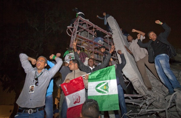 In this photo made on a government-organized trip, supporters of Moammar Gadhafi react following an airstrike in Tripoli, Libya, early Monday, April 25, 2011. The air strike on Gadhafi's sprawling residential compound early Monday badly damaged two buildings, including a structure where Gadhafi often held meetings, guards at the complex said. In this photo made on a government-organized trip, supporters of Moammar Gadhafi react following an airstrike in Tripoli, Libya, early Monday, April 25, 2011. The air strike on Gadhafi's sprawling residential compound early Monday badly damaged two buildings, including a structure where Gadhafi often held meetings, guards at the complex said.